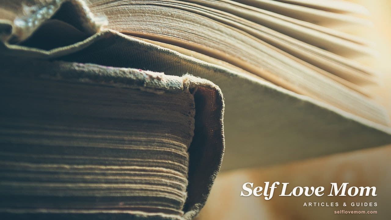 An open book on a windowsill in soft golden afternoon light.