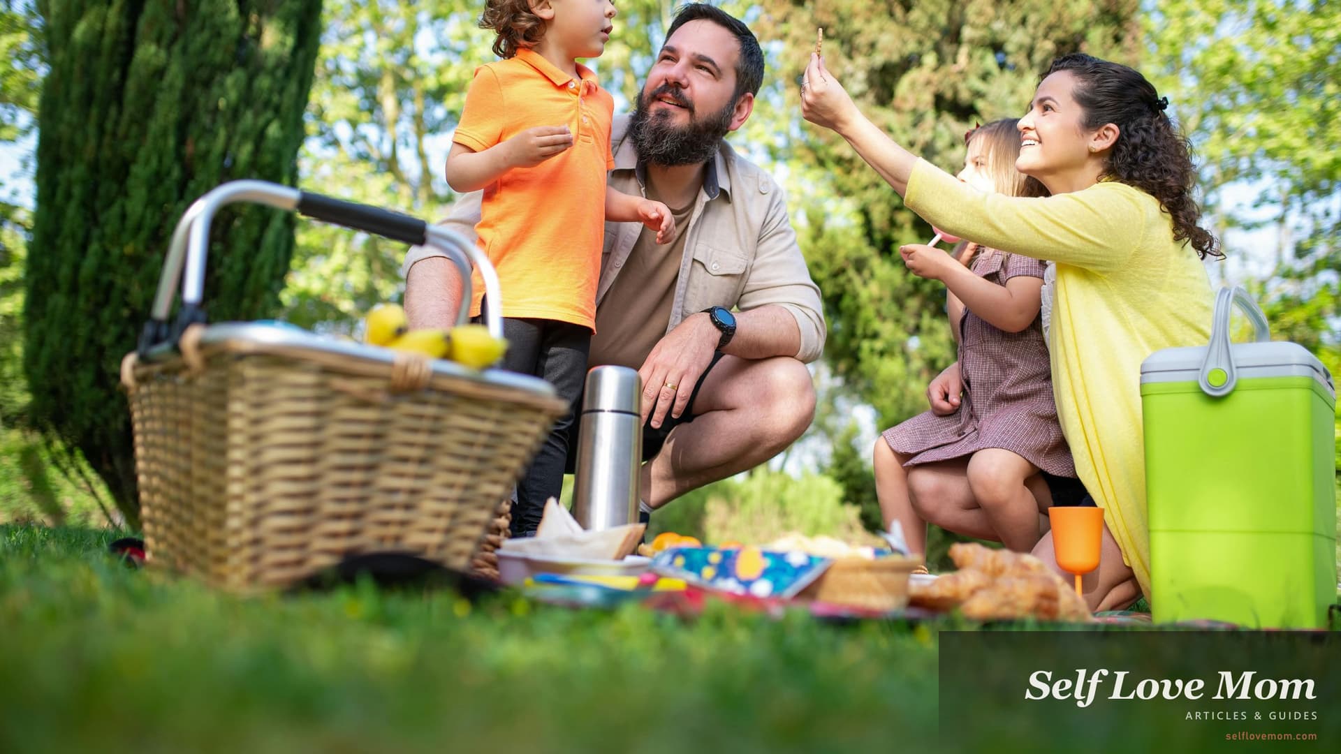 A family enjoying a picnic in the park, the kind of free Memorial Day activity that fits a single-mom budget.
