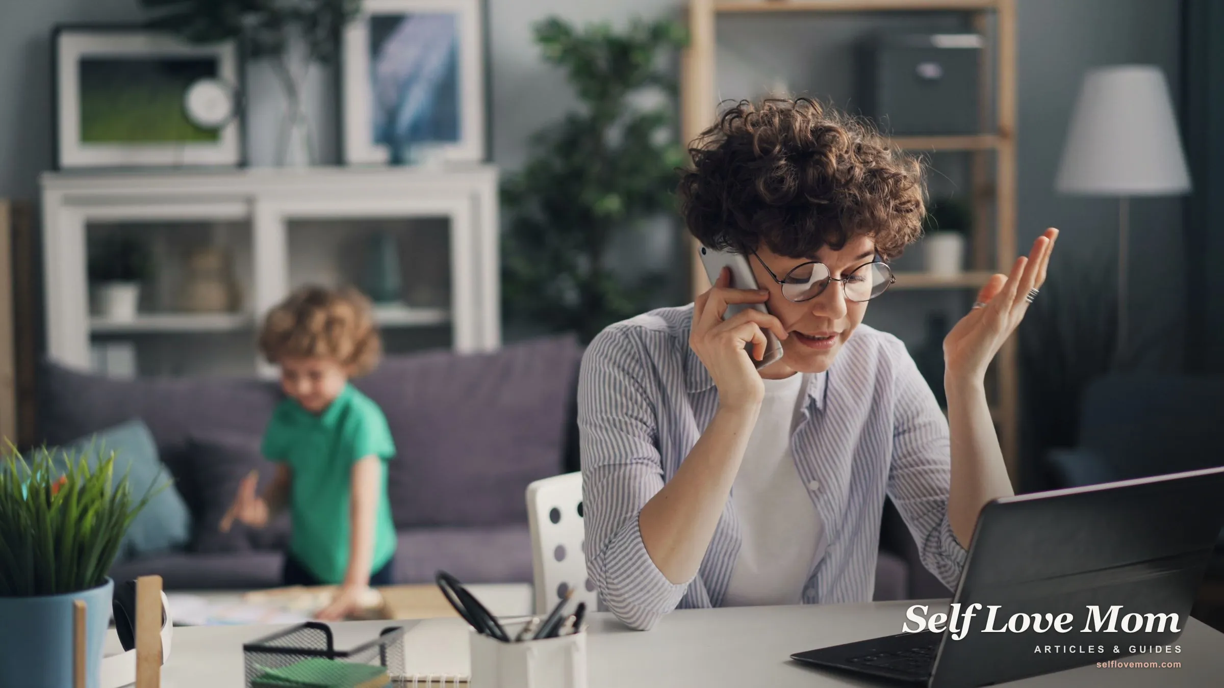A single mom manages money on her phone and laptop while her son plays, the multitasking an AI budgeting tool simplifies.