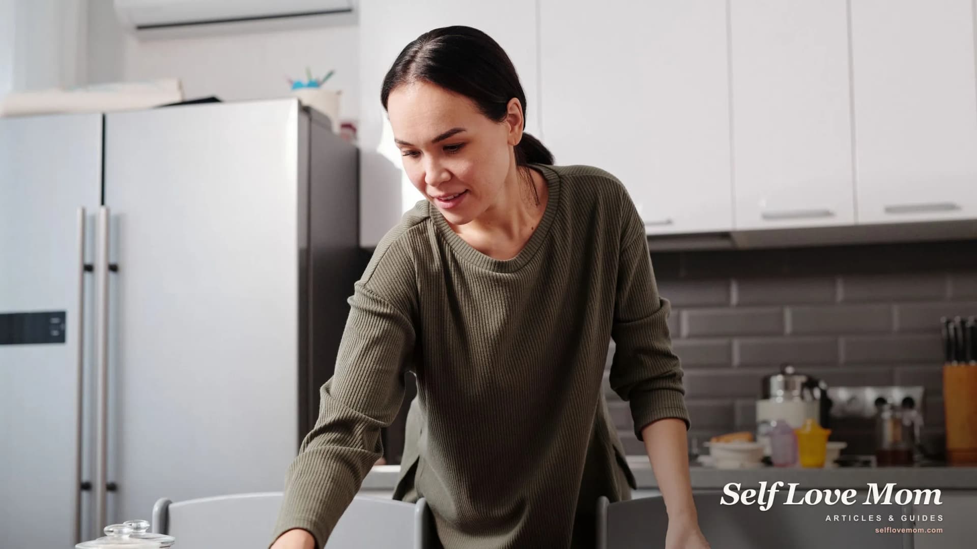 A working mom wipes down the kitchen table during a quick cleaning reset.