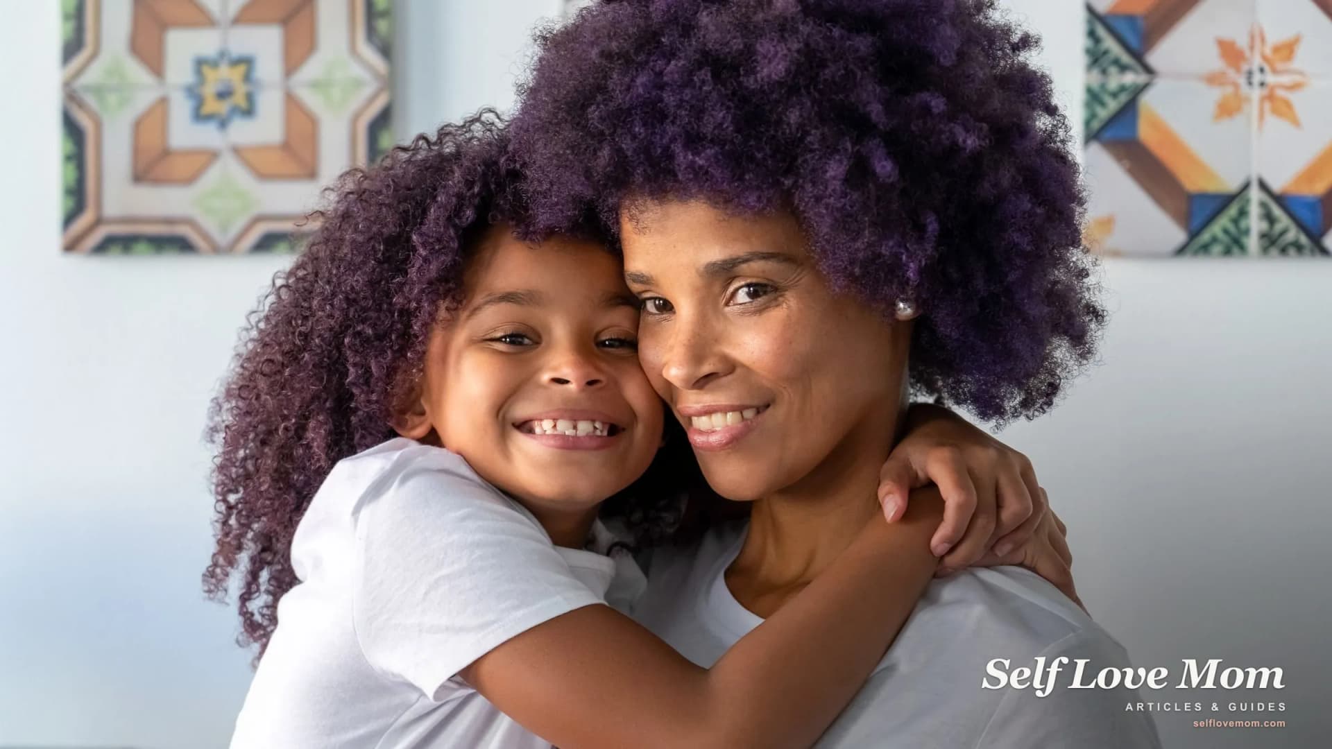 A mother and daughter share a warm cheek to cheek hug, the unconditional love at the heart of motherly qualities.