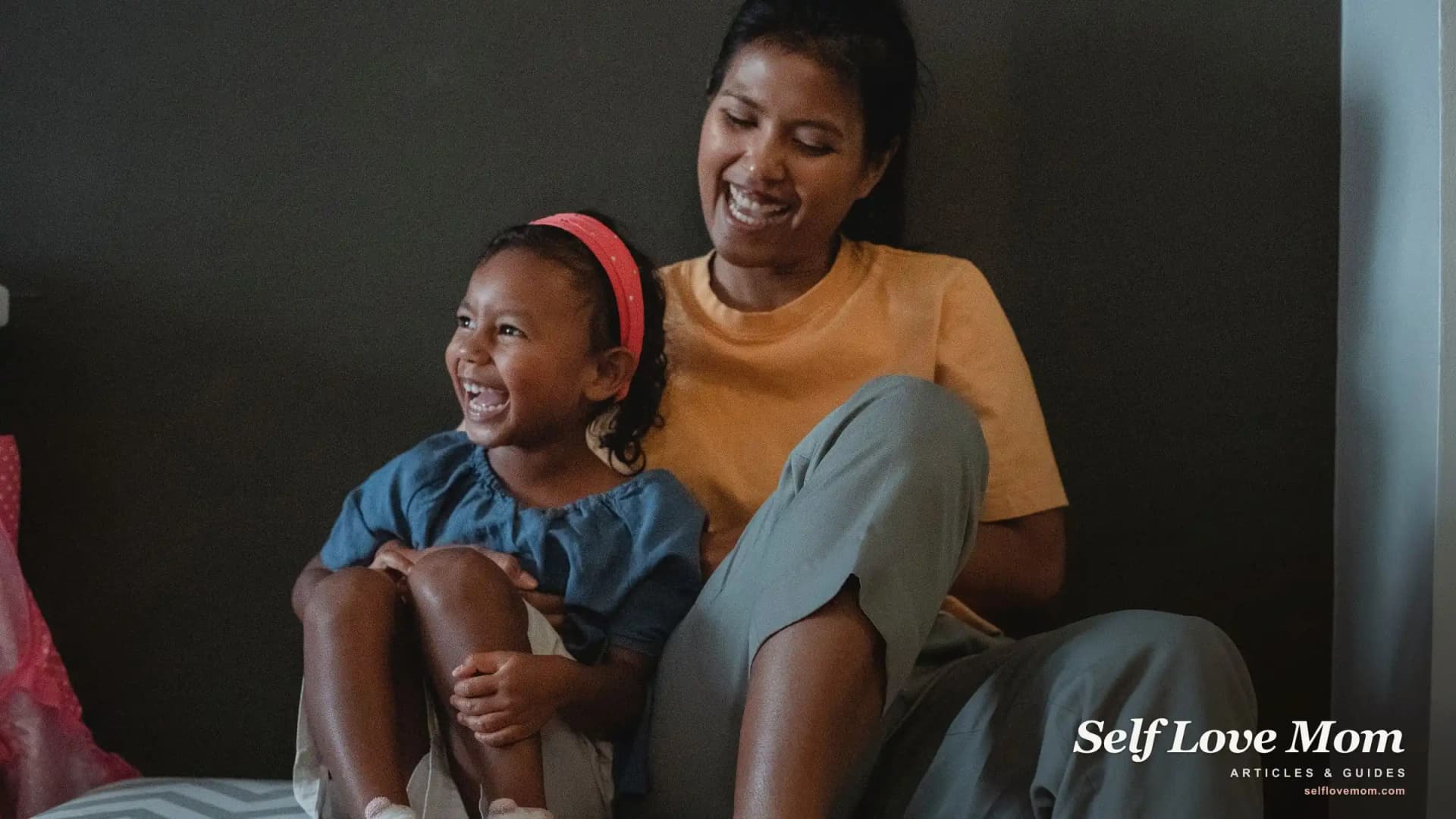 A single mom laughs with her young daughter at home, the hopeful side of facing single-parent challenges and overcoming them.