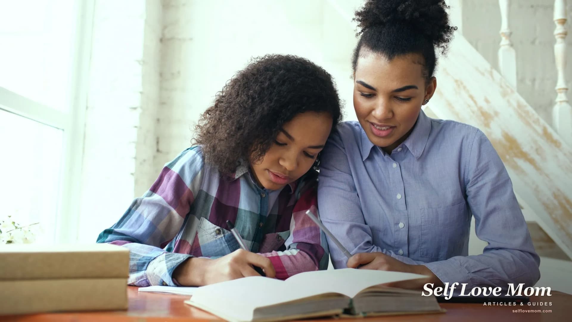 A single mom and her daughter plan the week together at the table, mapping out a calmer daily routine.