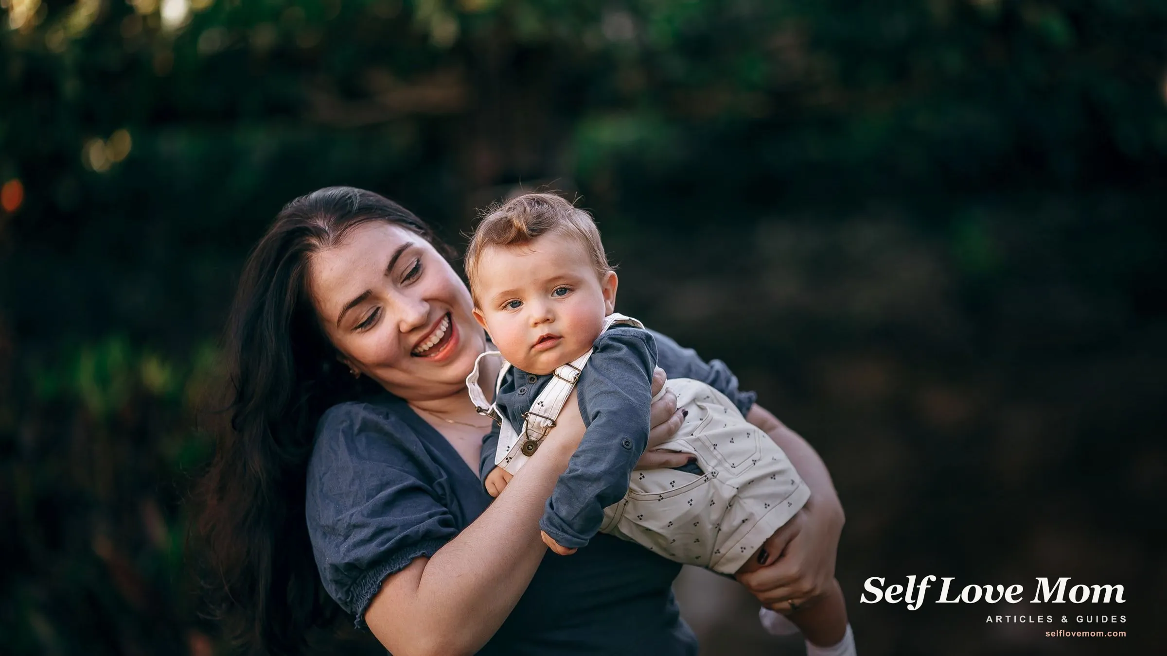 A single mom smiles while holding her baby outdoors, the kind of family free diaper programs are there to support.
