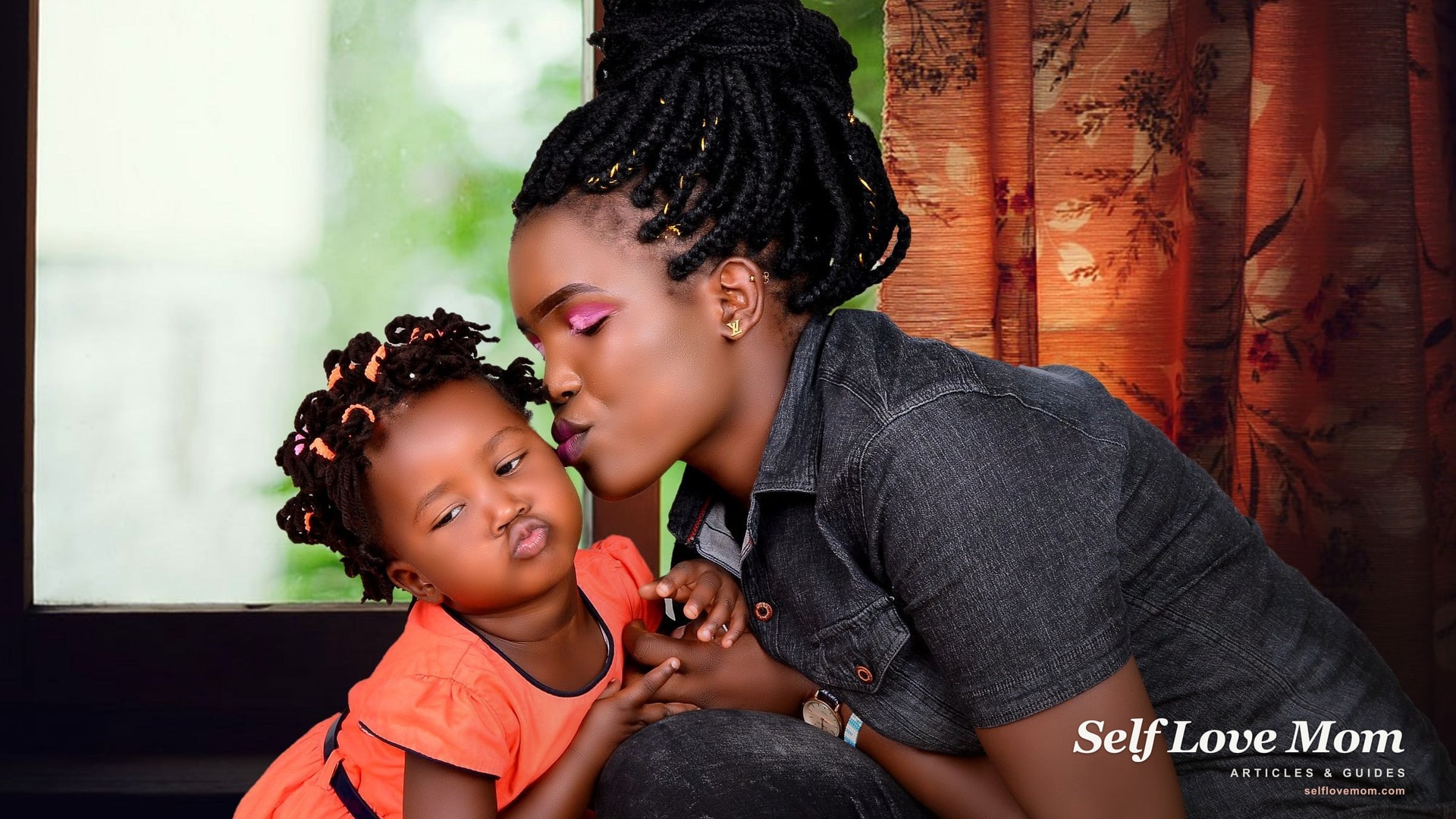 A mother lovingly kisses her young child at home, the warm bond that support for new moms helps protect.