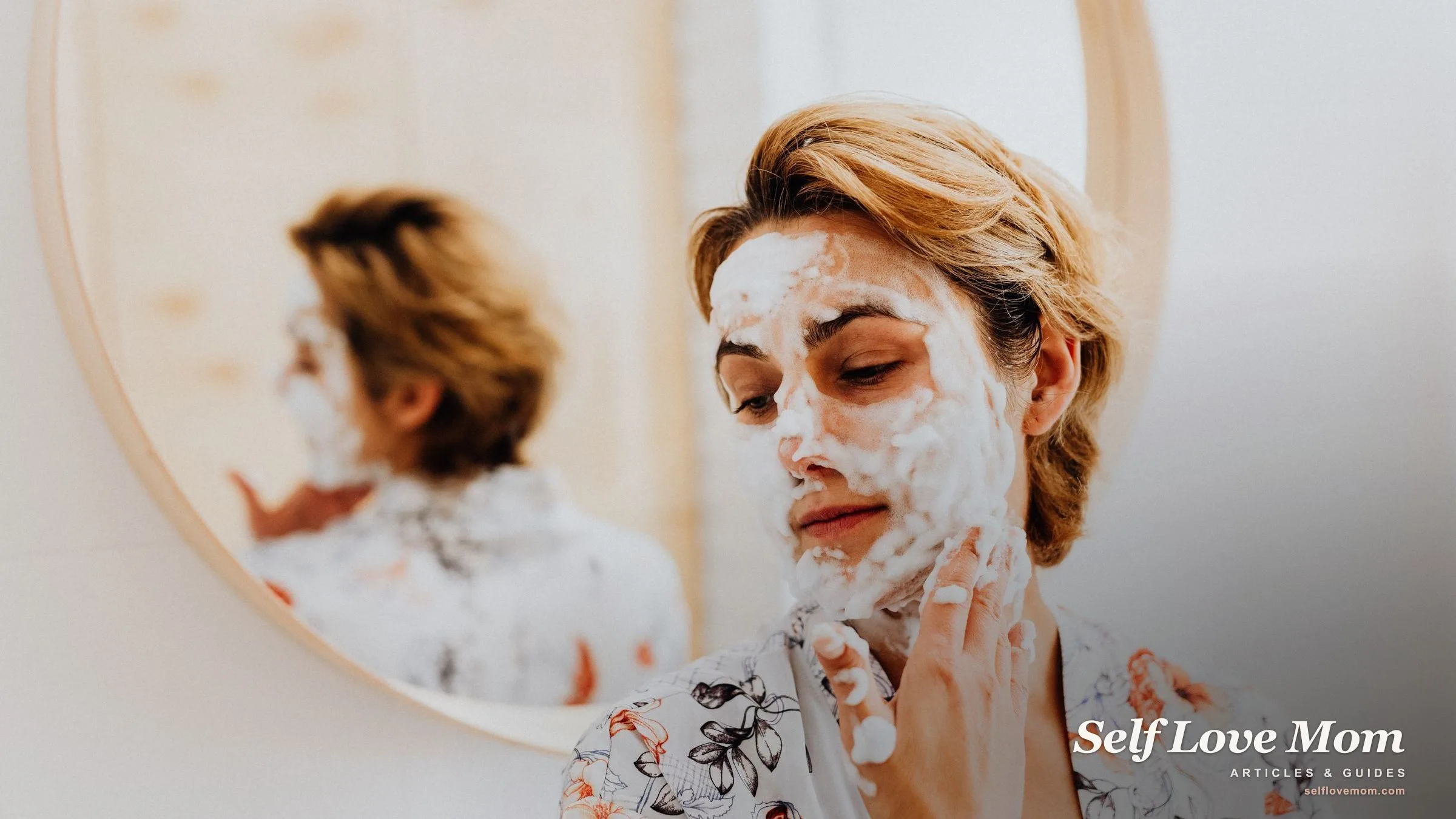 A mom applies a homemade face mask at a round mirror, a simple DIY self-care moment at home.