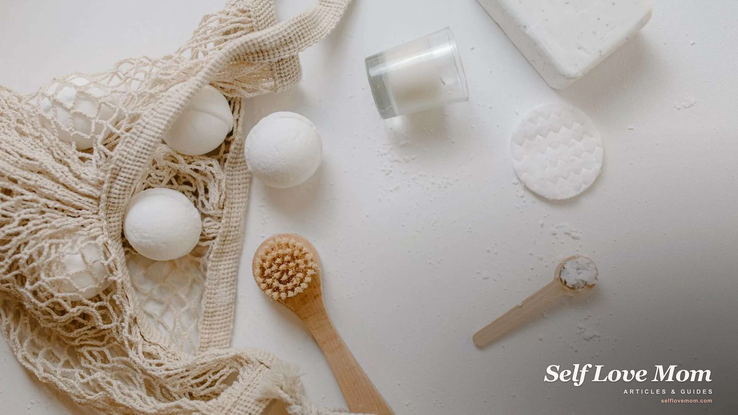 A self-care kit of bath bombs, a dry brush, candle, and soap laid out, the kind of bundle a busy mom can grab.