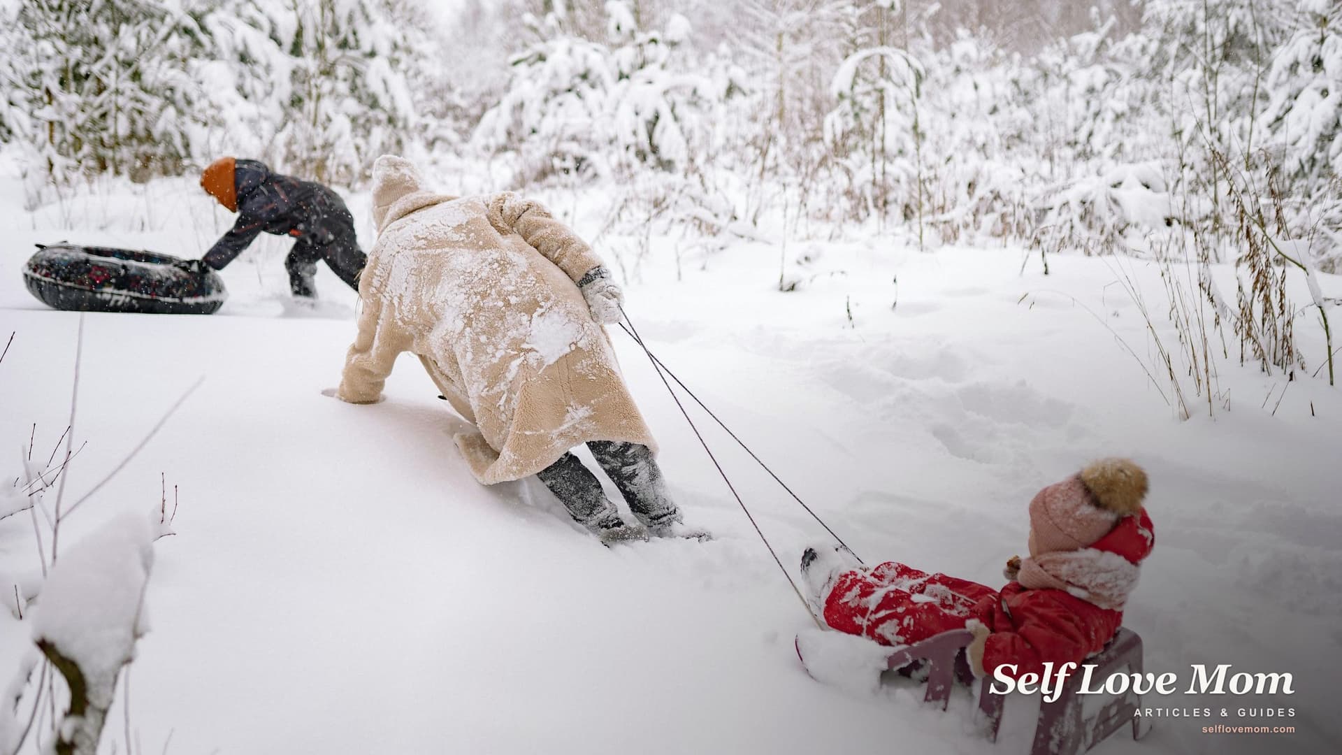 A mother and her two children sledding together in deep snow on a bright winter afternoon, dressed in warm winter coats and laughing.