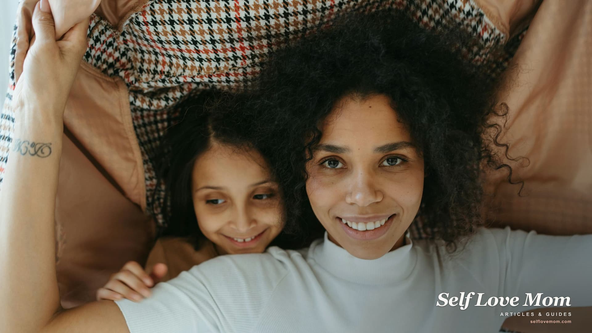 A single mom and her daughter look up from researching personal loans, hopeful about the right path forward