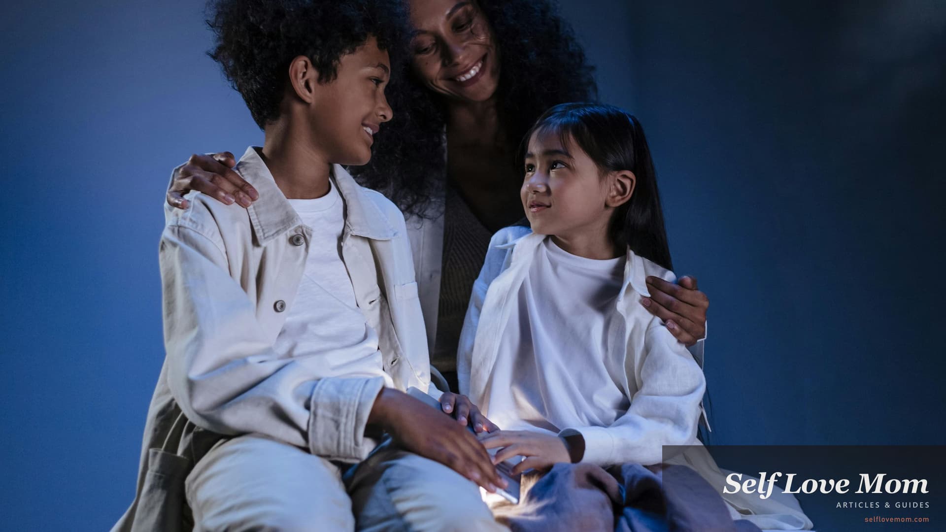 A single mom embraces her son and daughter close, the everyday warmth this resource hub is built to support, every single-mom program in 2026 covered in one place from cash and food to housing, childcare, and mental-health help.