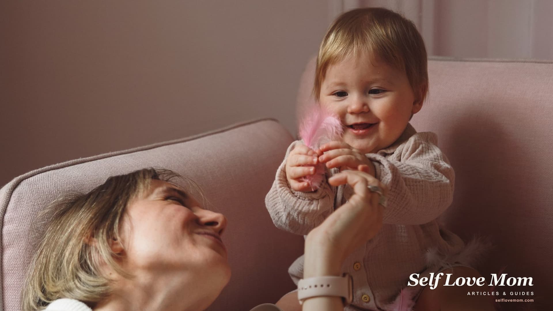A single mom smiles with her baby at home, the kind of family that charities for single mothers help with grants, food, and housing.