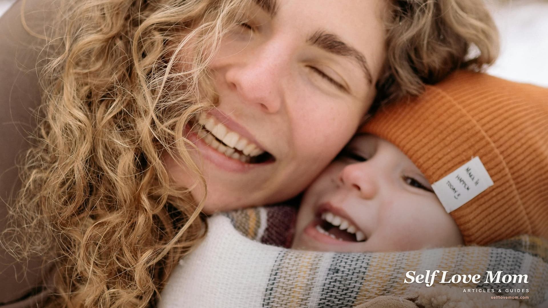 A mother laughs cheek to cheek with her child outdoors: homeless single moms can still get SNAP food stamps.