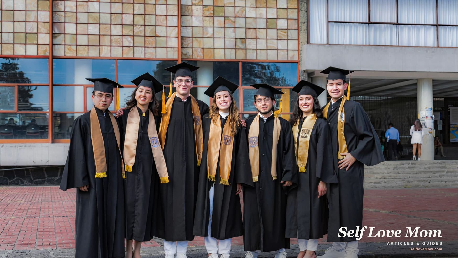 Graduates in caps and gowns smile together on a campus, the milestone scholarships for single mothers in Georgia help make possible.