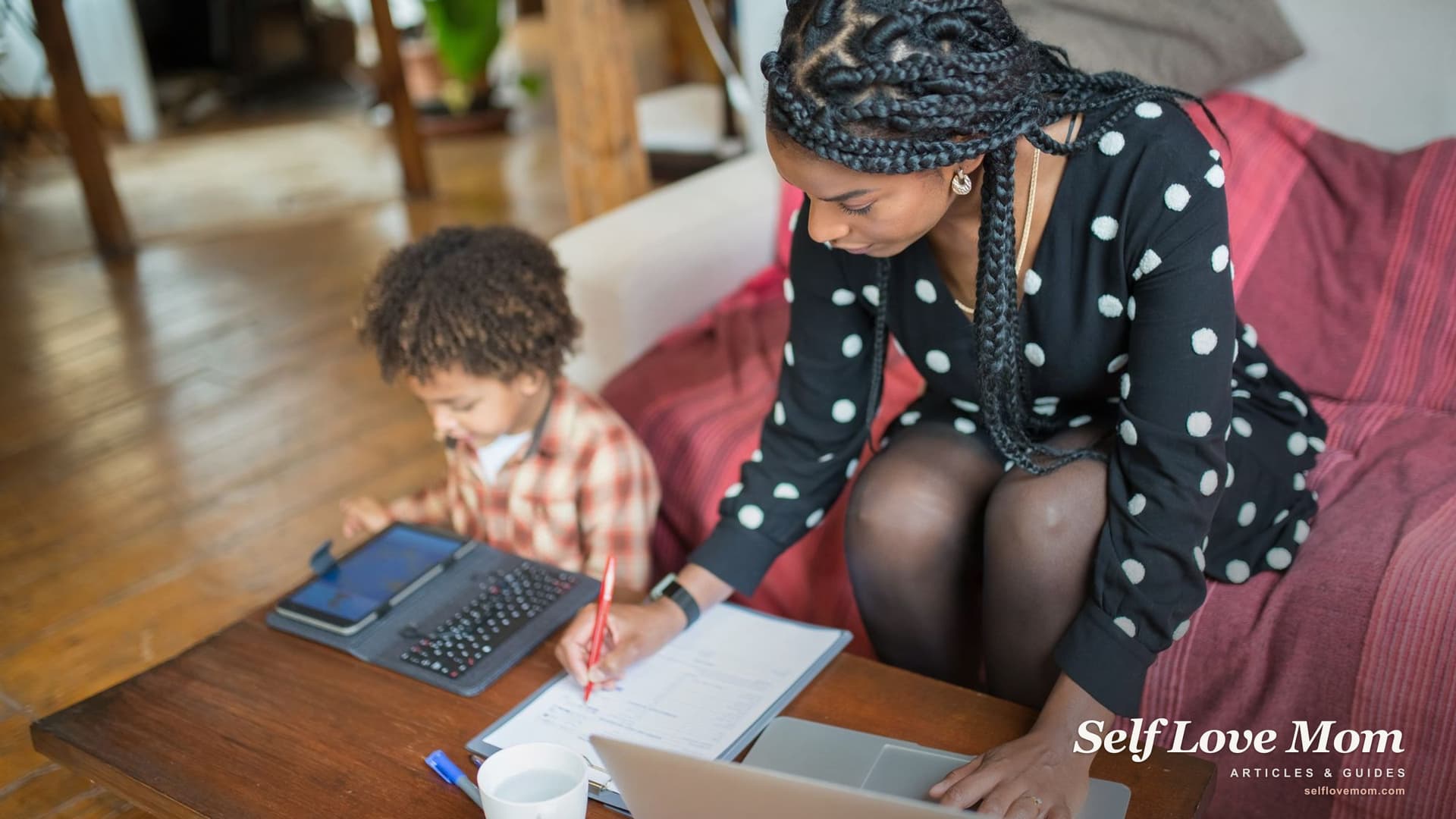 A single mom fills out a benefits application at home with her laptop while her son sits beside her, the kind of family Washington State TANF helps.