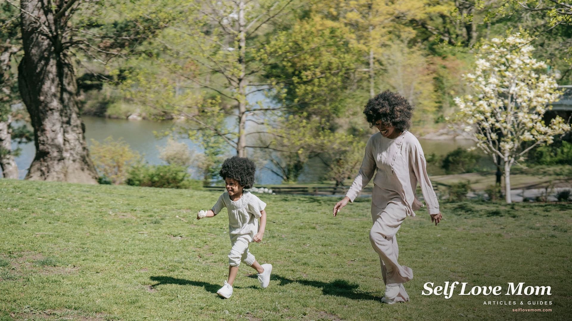 A mother and her young child walking together through a sunny spring park, a hopeful image of moving forward and healing after a divorce.