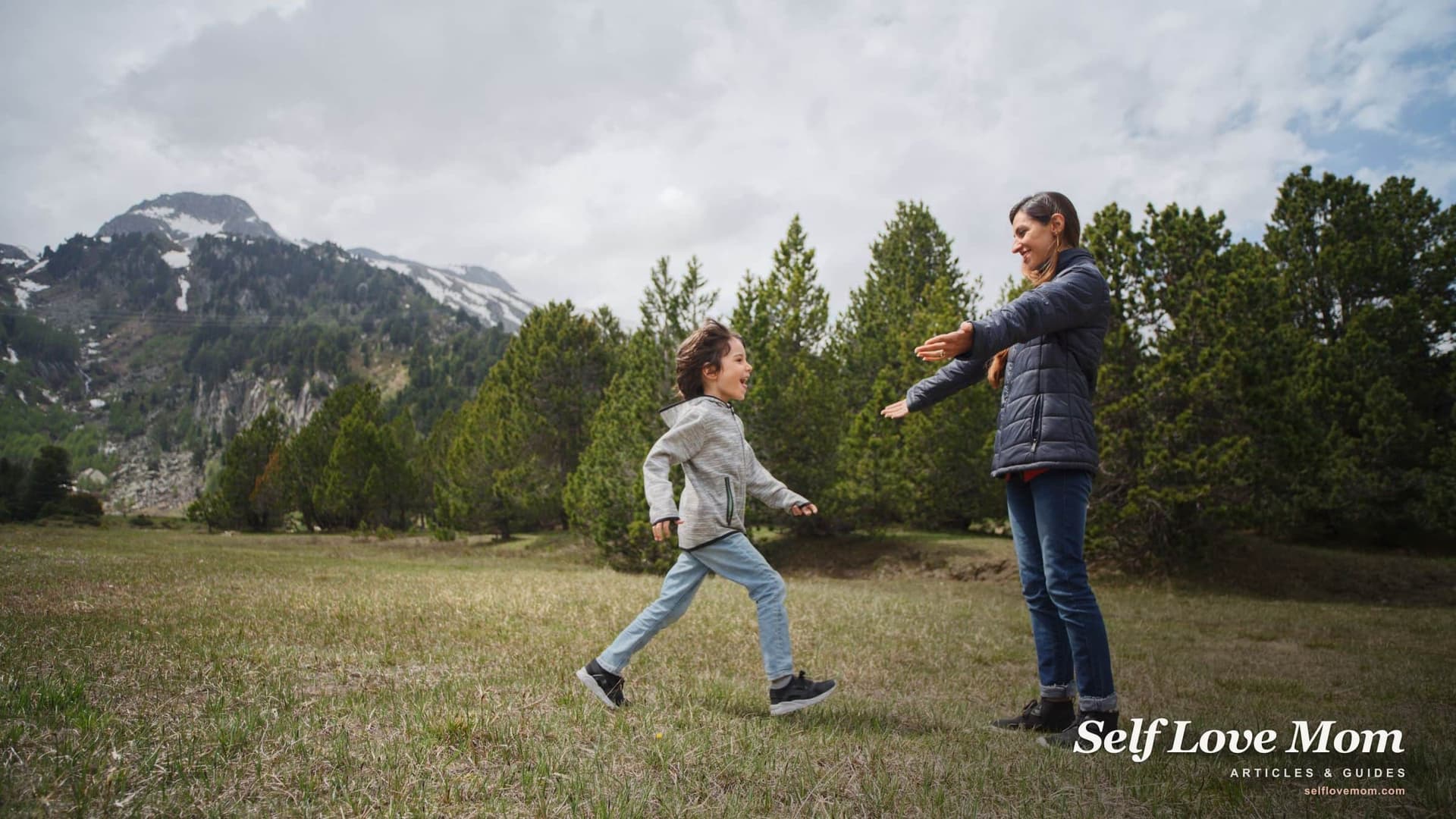 A mother opens her arms as her young child runs to her across a mountain meadow, the kind of everyday care Colorado child support helps pay for.