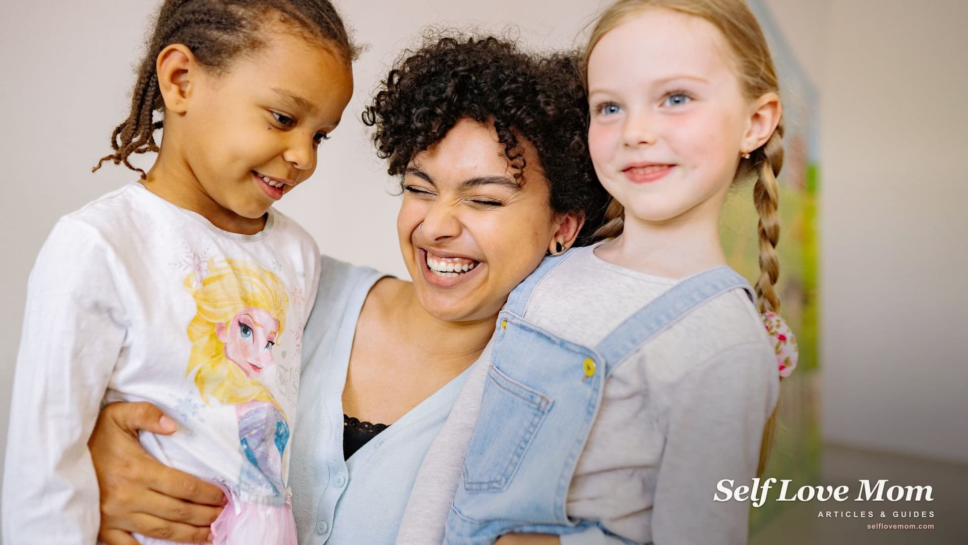 A smiling single mom hugs her two young daughters at home, the household Florida child support is meant to help.