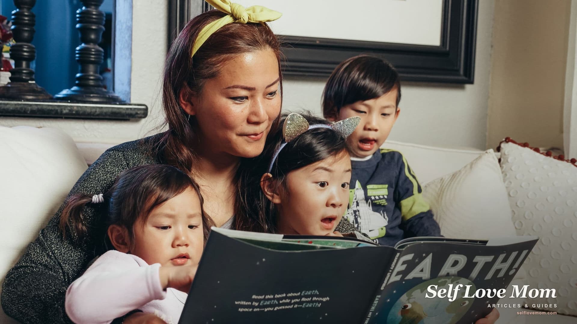A single mom reads a picture book about Earth to her two daughters and son on the living room sofa, the kind of family that grants for single mothers in Connecticut are meant to help.