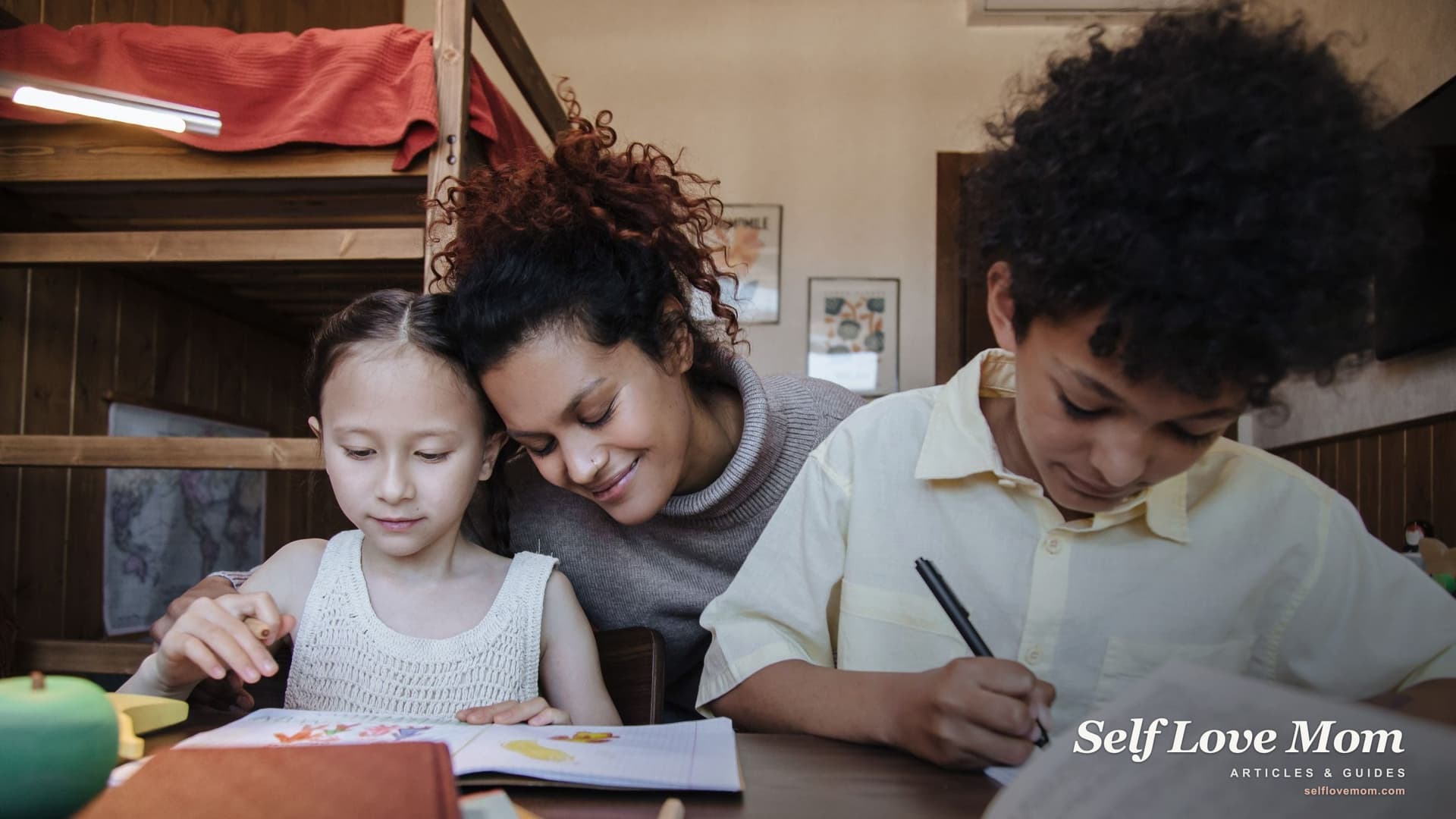 A single mom smiles as she helps her daughter and son with homework at a table beside their bunk beds, the kind of household that grants for single mothers in Nevada are meant to serve.