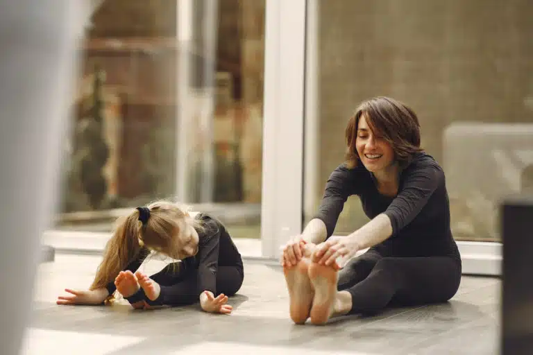 Single mom practicing easy self-care tips at home with her child