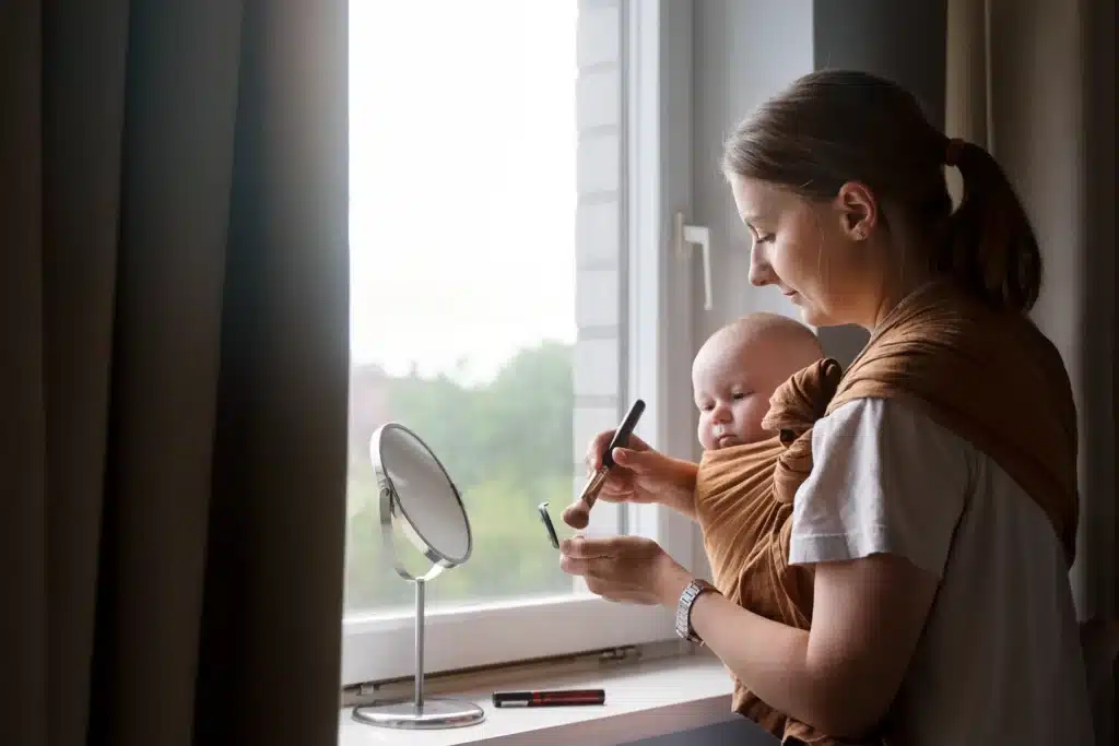 Single mom holding her baby while practicing self-care at home