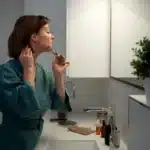 Busy mom practicing self care night routine with jade roller for relaxation at home