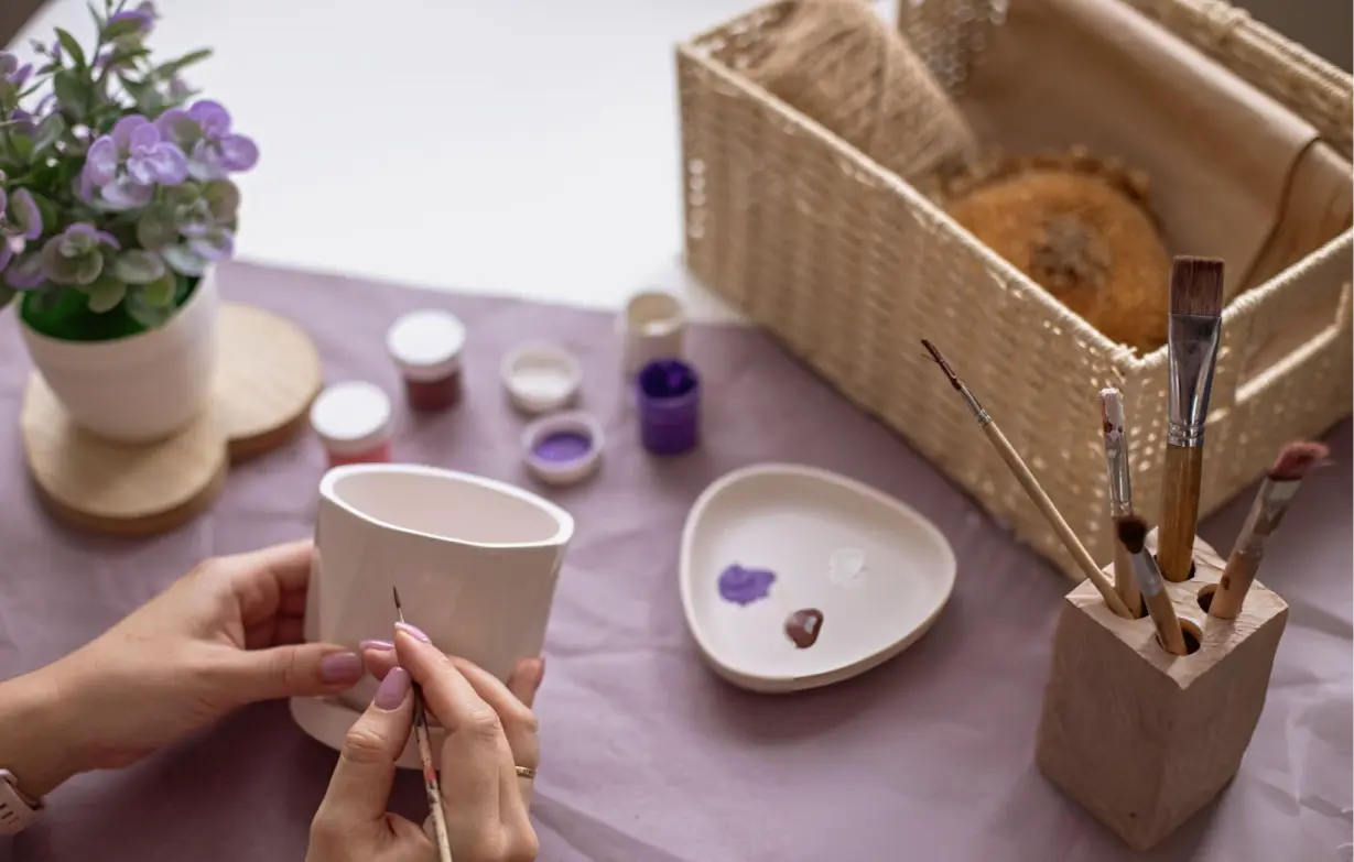 A creative self care gift basket for women with coloring books, pencils, candles, and craft supplies to inspire relaxation and creativity.