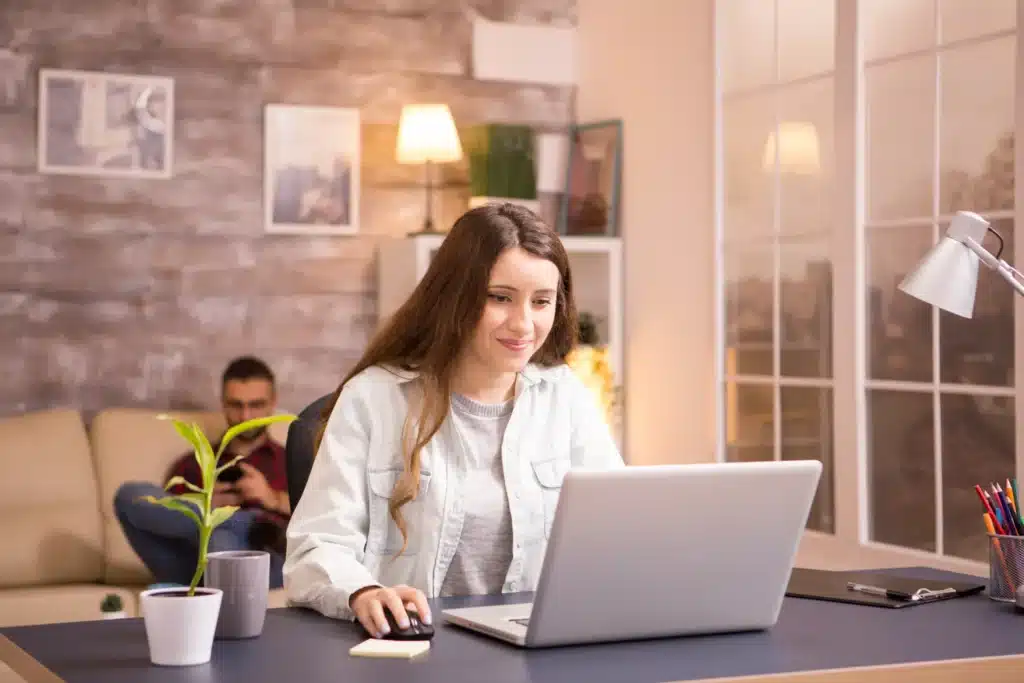 Stay-at-home mom working on laptop exploring online business ideas from home.
