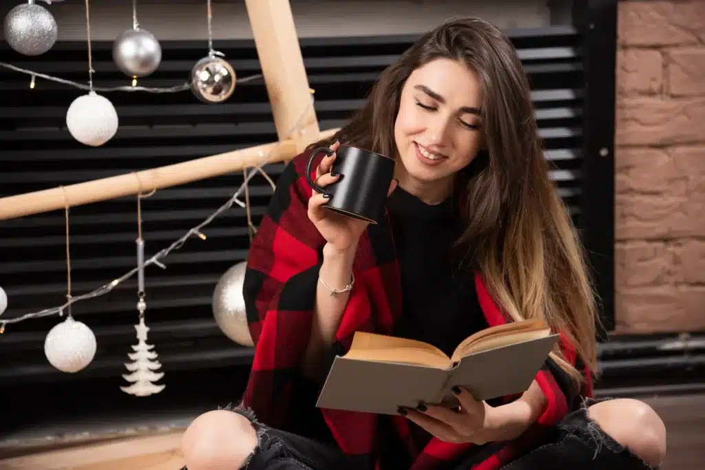 A single mom relaxing with a book and coffee, practicing self-care and emotional healing through therapy and mindfulness.