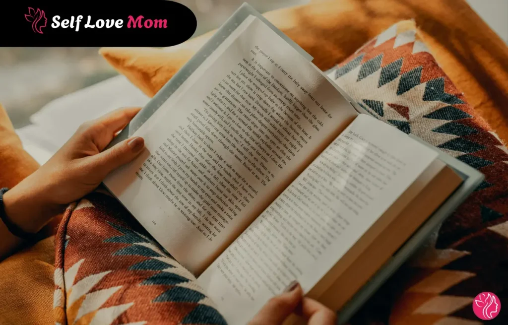 Woman reading one of the 9 best books on single parenting while relaxing on a cozy couch with patterned cushions
