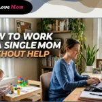A single mom learning how to work as a single mom without help, typing on her laptop at a home office desk while her young daughter plays independently with colorful building blocks nearby.